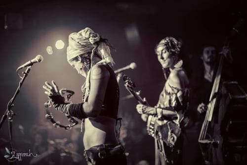 Rising Appalachia performing on stage. Rising Appalachia performing on stage.