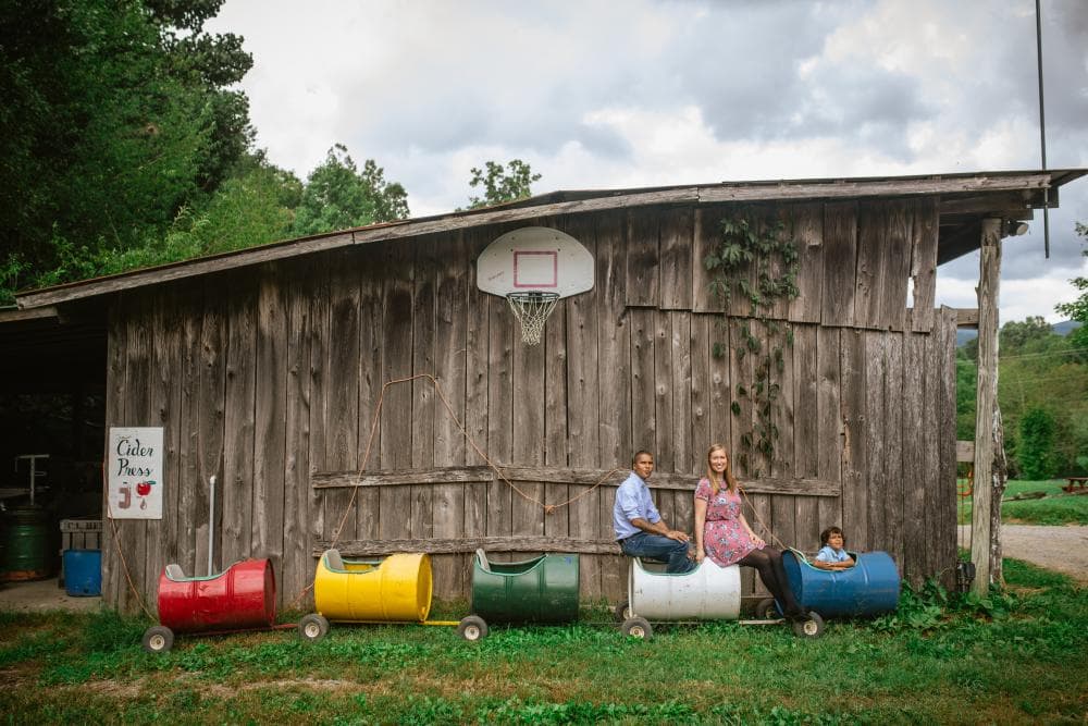 Family posing in front of barn at Hickory Nut Gap Farm Family posing in front of barn at Hickory Nut Gap Farm