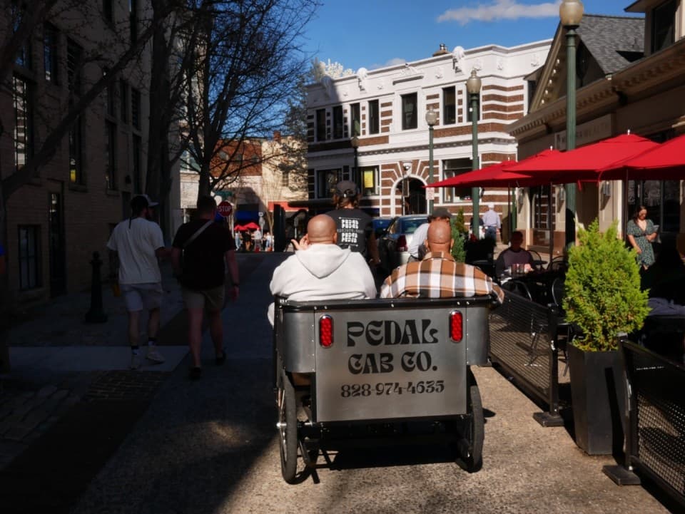 A passenger once told us, "Asheville is small town lit". We agree! Despite our small town mountain feel, Asheville has so much to offer, and it's growing and changing everyday. To help you get the most out of your time in downtown Asheville, we offer 30 minute tours of the downtown area. We highlight local eateries, can't miss late night spots, hidden gems, and sprinkle in some Asheville history along the way. Whether you're a seasoned local, a visitor on a mission to see all of Asheville's loca A passenger once told us, "Asheville is small town lit". We agree! Despite our small town mountain feel, Asheville has so much to offer, and it's growing and changing everyday. To help you get the most out of your time in downtown Asheville, we offer 30 minute tours of the downtown area. We highlight local eateries, can't miss late night spots, hidden gems, and sprinkle in some Asheville history along the way. Whether you're a seasoned local, a visitor on a mission to see all of Asheville's loca