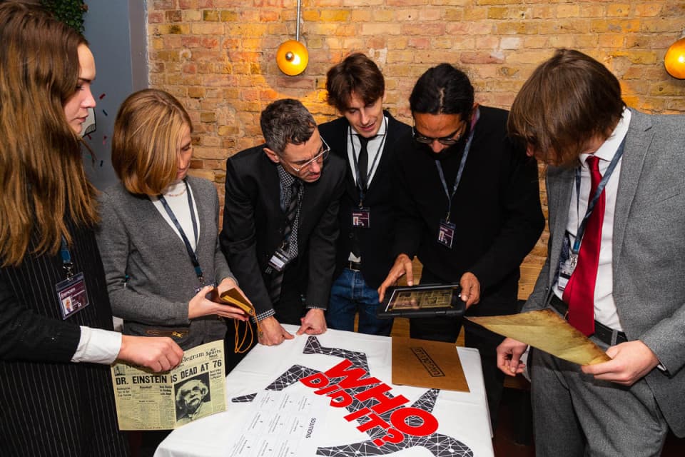 Trying to solve the puzzles and beat out the other teams competing Trying to solve the puzzles and beat out the other teams competing