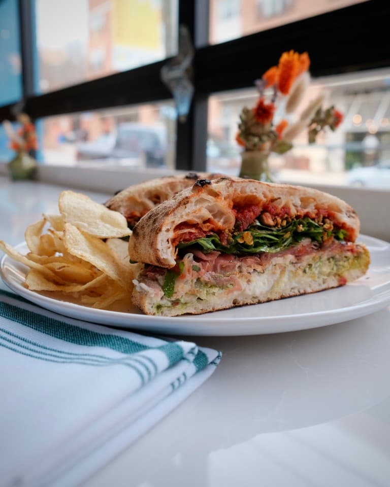 porchetta, prosciutto, tomato conserva, calabrian chili, pesto, stracciatella, arugula, pistachio, balsamic, lemon vinaigrette porchetta, prosciutto, tomato conserva, calabrian chili, pesto, stracciatella, arugula, pistachio, balsamic, lemon vinaigrette