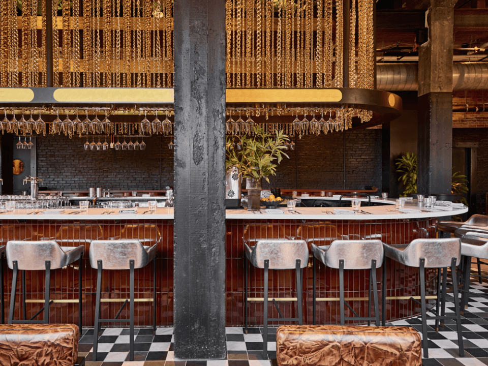 Racetrack bar with red tile and silver chairs under a curtain of gold chains Racetrack bar with red tile and silver chairs under a curtain of gold chains
