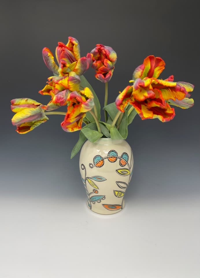 Handmade vase with vine decoration in orange, turquoise, yellow and black. Wheel-thrown and illustrated. Gorgeous tulips from Blazing Star Flower Farm. Handmade vase with vine decoration in orange, turquoise, yellow and black. Wheel-thrown and illustrated. Gorgeous tulips from Blazing Star Flower Farm.