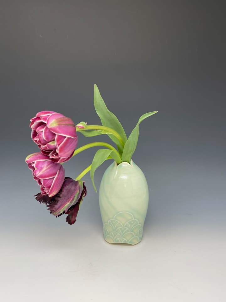 Handmade petal vase. Wheel-thrown using white stoneware clay. Slip trailing deco in a mermaid pattern. Glazed in Aqua. Tulips from Blazing Star Flower Farm in Alexander, NC. Handmade petal vase. Wheel-thrown using white stoneware clay. Slip trailing deco in a mermaid pattern. Glazed in Aqua. Tulips from Blazing Star Flower Farm in Alexander, NC.