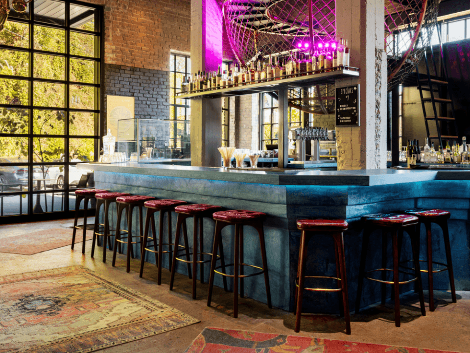 bright blue bar with red topped stools and alcohol on a high shelf bright blue bar with red topped stools and alcohol on a high shelf