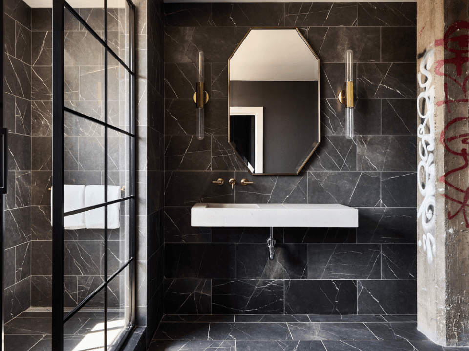 sun lit black tile bathroom with windowed shower and floating sink sun lit black tile bathroom with windowed shower and floating sink
