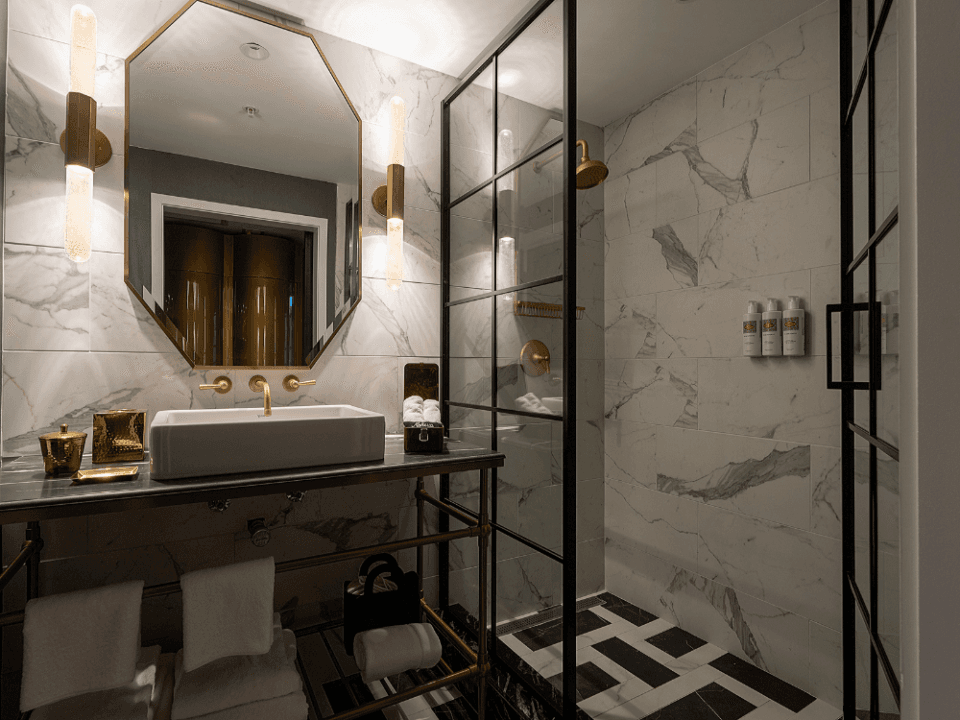 white tiled bathroom with hexagonal mirror and window walk in shower white tiled bathroom with hexagonal mirror and window walk in shower