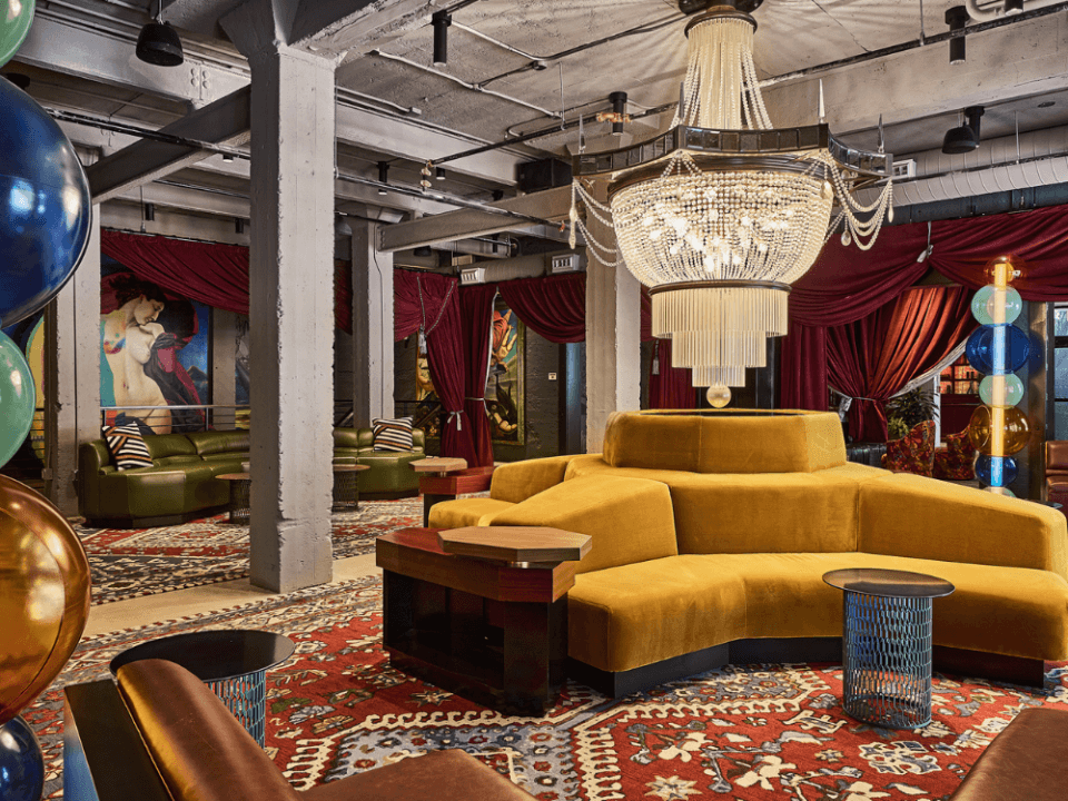 bright yellow couch in a room with red velvet curtains and a crystal chandelier on red oriental rugs bright yellow couch in a room with red velvet curtains and a crystal chandelier on red oriental rugs