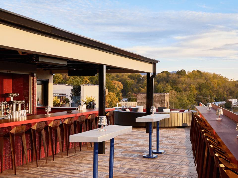 rooftop bar with high top tables and the mountains in the background rooftop bar with high top tables and the mountains in the background