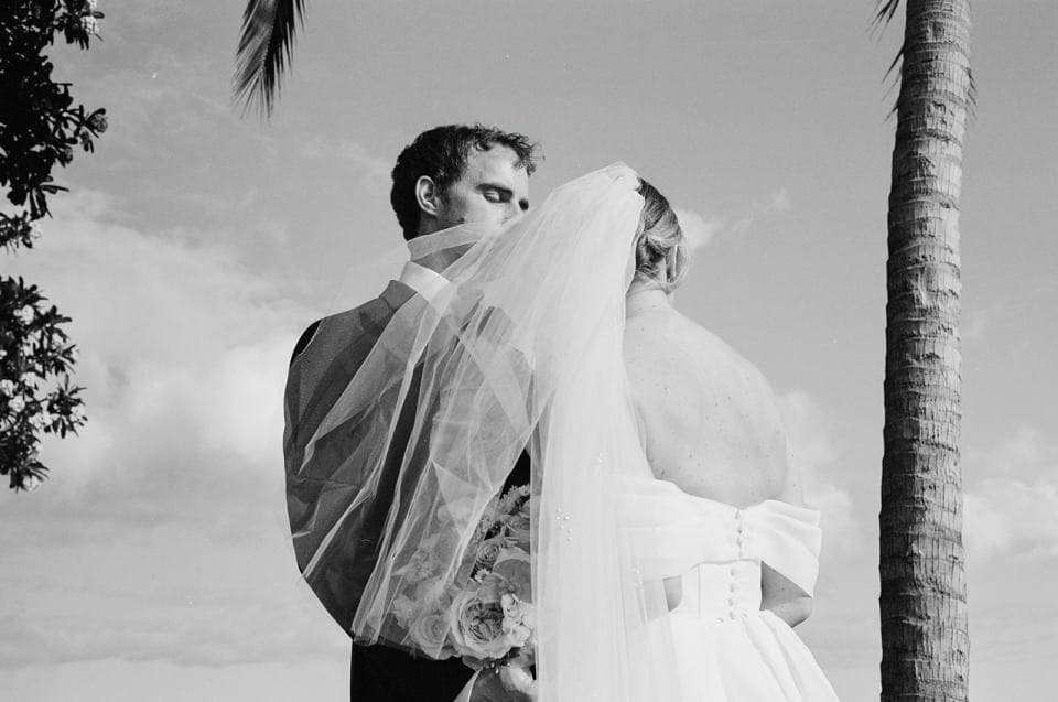 Newlyweds enjoying that just married bliss on black and white film Newlyweds enjoying that just married bliss on black and white film