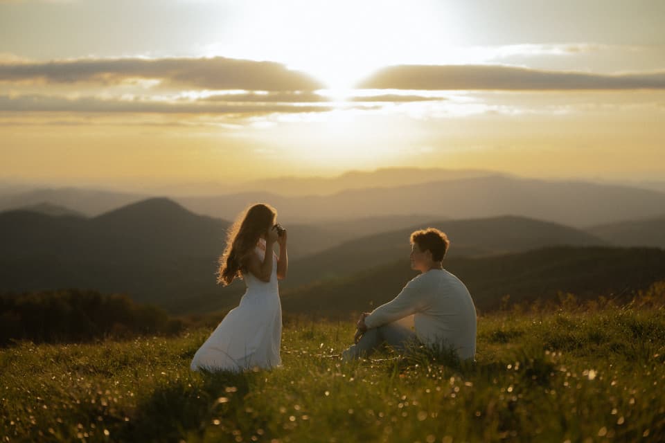 A couple taking photos for an engagement session in the mountains of Asheville. A couple taking photos for an engagement session in the mountains of Asheville.