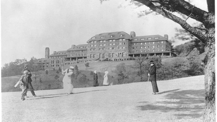 A historical black-and-white image of the Grove Park Inn in Asheville