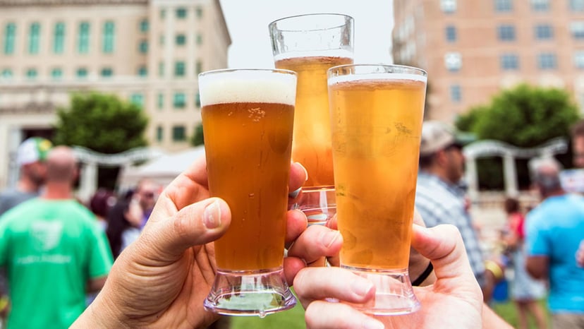 Three pints of beer are being toasted at an Oktoberfest festival in Asheville