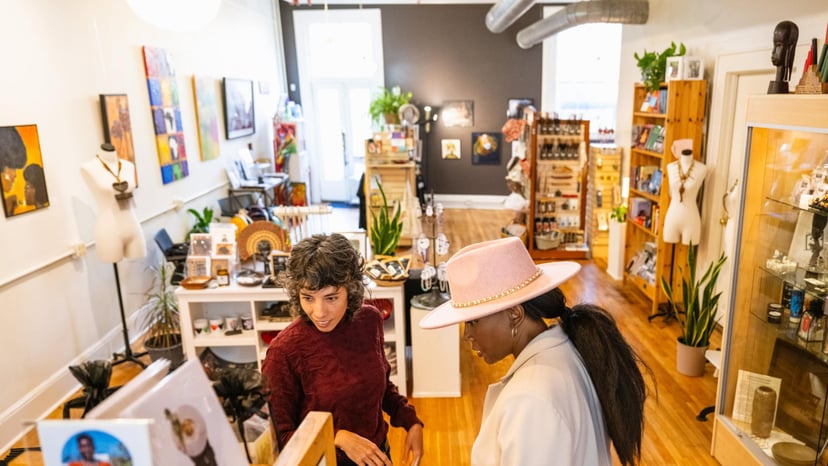 Women shopping Downtown looking at pottery