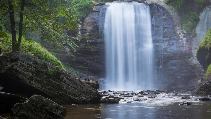 A cascading waterfall surrounded by greenery in Asheville
