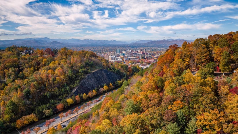 Image of downtown Asheville surrounded by fall foliage